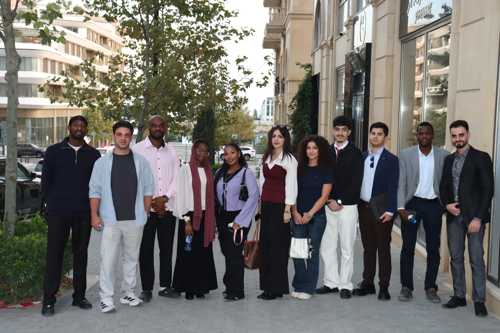 The EtudyGo team and international students smiling together in a group photo outdoors