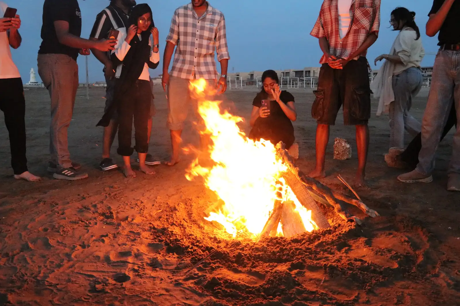 EtudyGo Student Union members around a bonfire on the beach