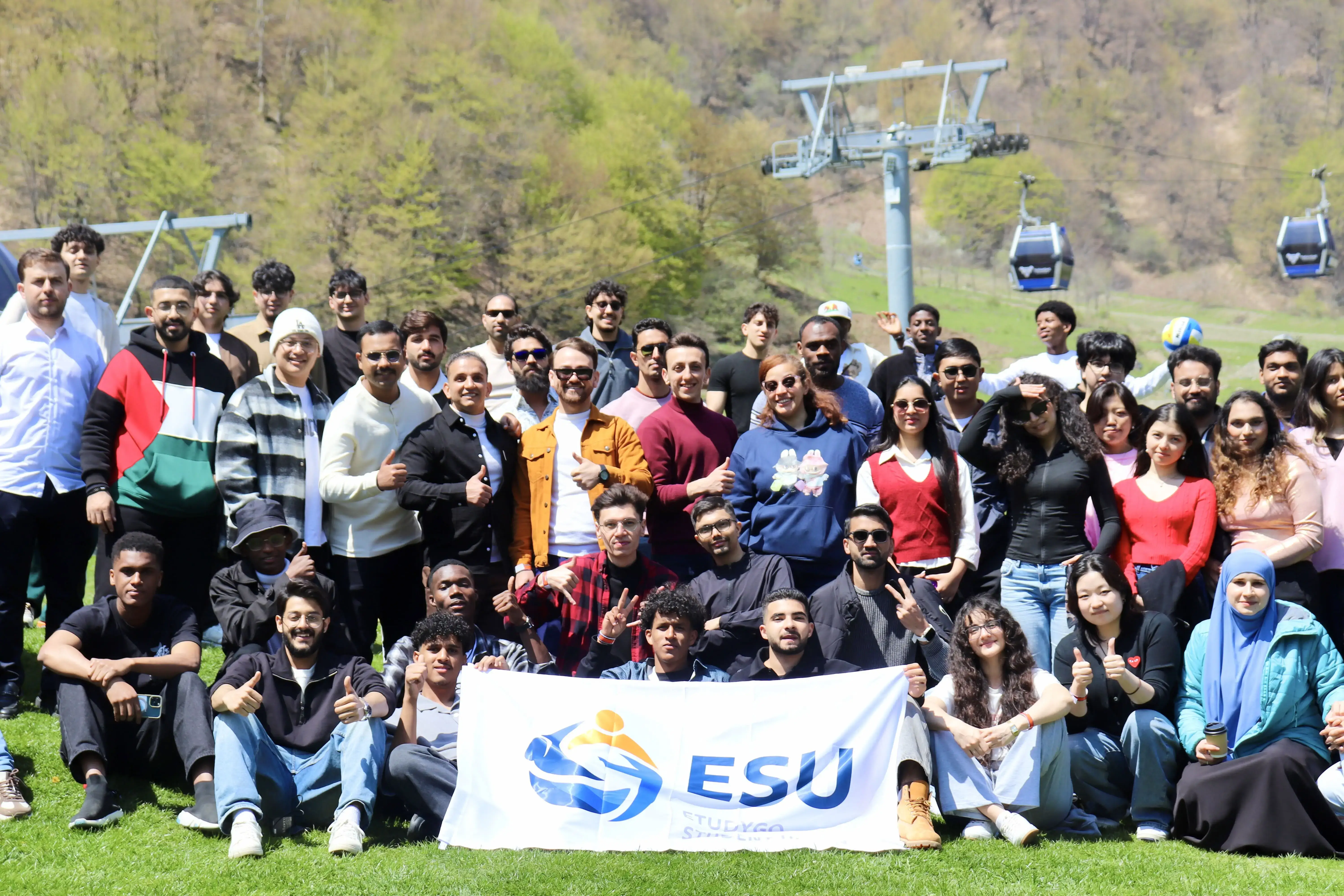 EtudyGo Student Union members gathered around the ESU banner on a mountain lawn in Gabala